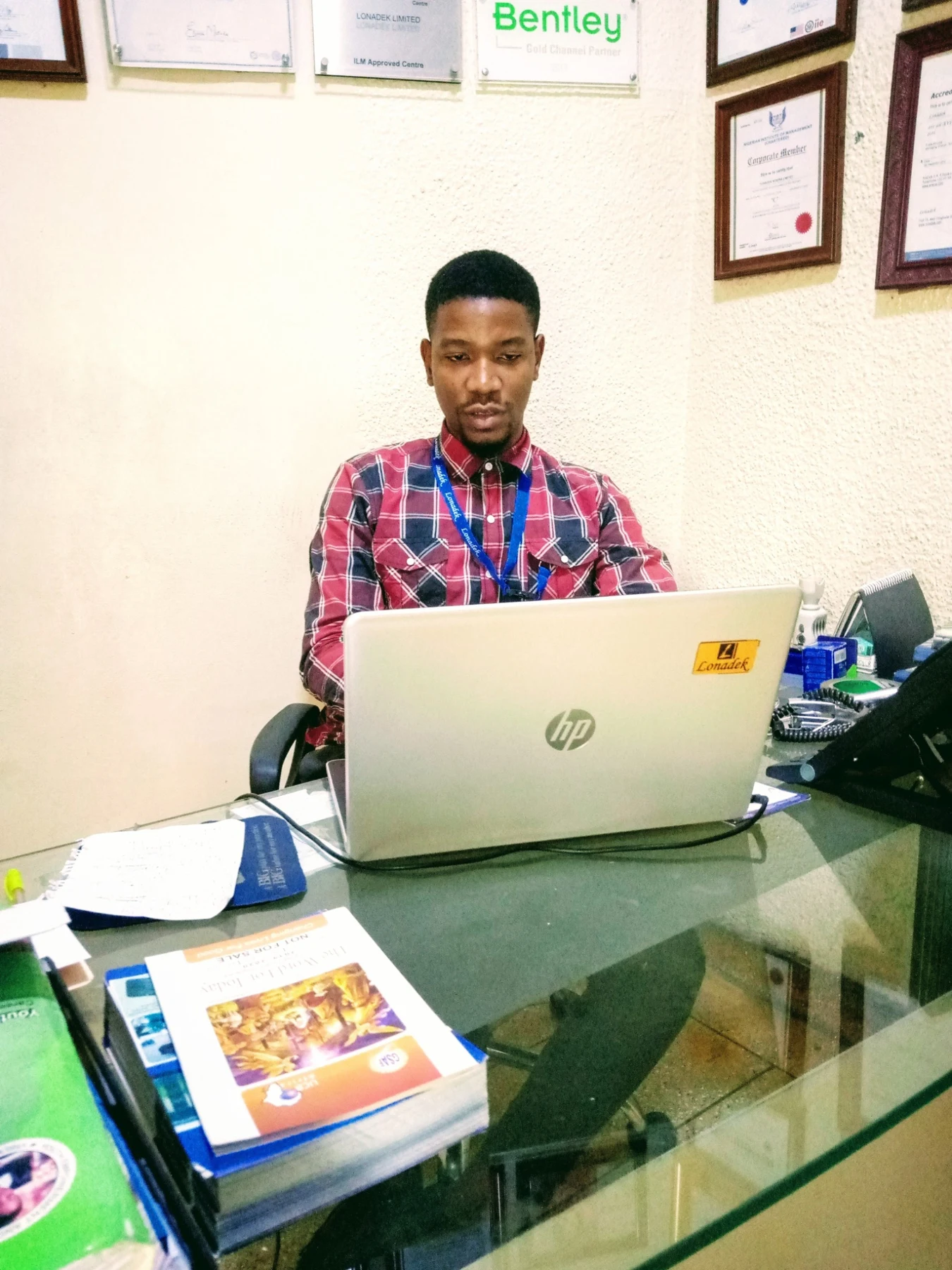 Uche working on his laptop in the office